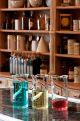 three berzelius glasses with colored liquid