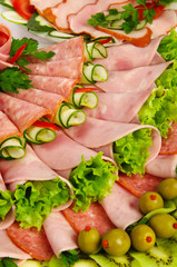 rolls of cold meat garnished with lettuce