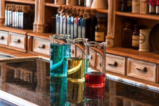 three berzelius glasses with colored liquid