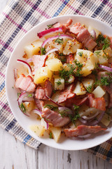 Potato salad with bacon and onions in  close up. vertical top view
