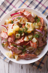 German potato salad with bacon close up. vertical top view

