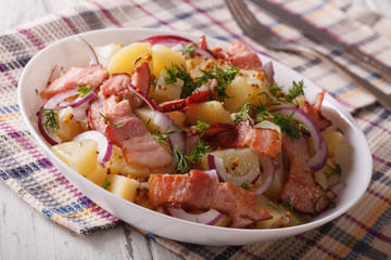 Potato salad with bacon soaked in mustard sauce close up. horizontal
