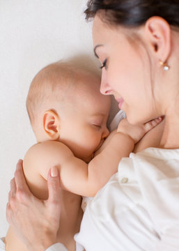 happy mother breastfeeding her baby infant