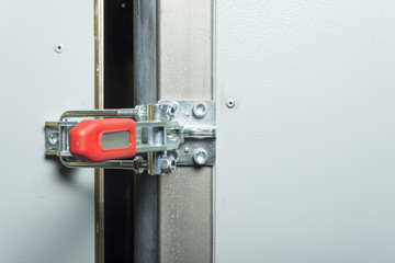 Toggle clamp on the refrigerator door.