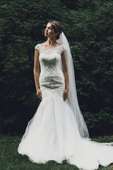 Fototapeta premium gorgeous elegant luxury happy bride posing on the background of
