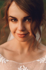 Obraz na płótnie Canvas portrait of gorgeous elegant happy bride on the background of be