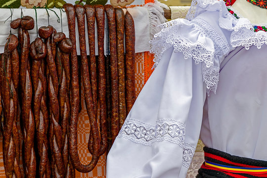 Romanian traditional sausages hanging on a fence. Specific costume
