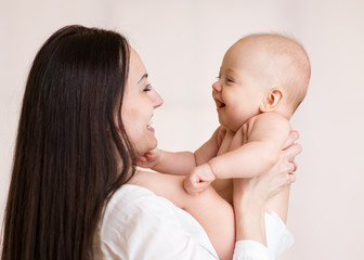 Mother holding smiling baby boy