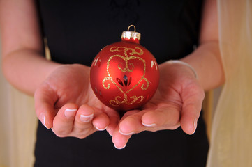 hands with christmas ball for decor