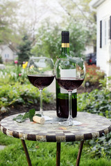 Bottle of Wine and glasses on a garden table