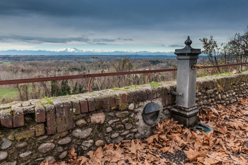 Water Fountain with panoramic view of snowy mountains in autumn
