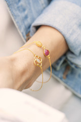 woman's hand wearing golden bracelets