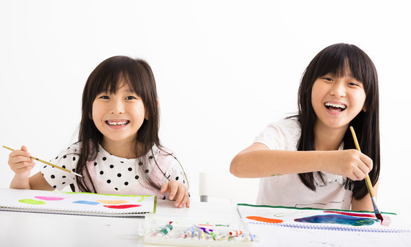 happy children painting in the classroom