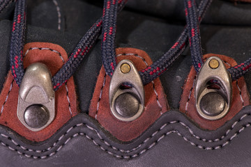 Detail of trekking shoes hook and loop for the strap.