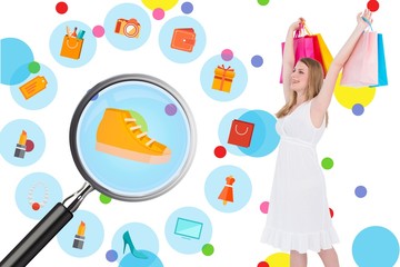 Smiling blonde woman standing with shopping bags