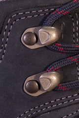 Detail of trekking shoes hook and loop for the strap.
