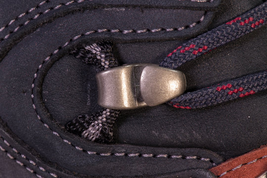 Detail of trekking shoes hook and loop for the strap.
