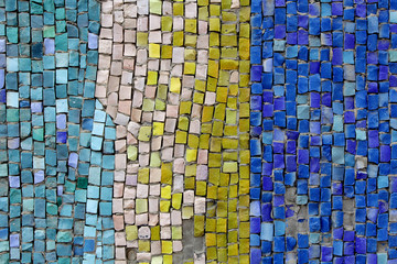 picture or pattern produced by arranging together small colored pieces of hard material, such as stone, tile, or glass