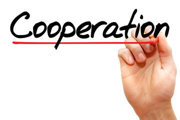 Hand writing COOPERATION with marker, business concept