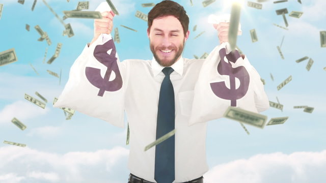 Composite video of businessman holding money bags 