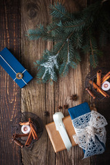 Presents with fir tree , spices and candles vertical