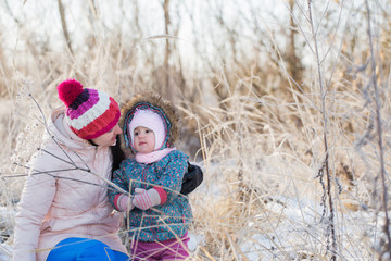 Happy family playing in winter outdoors