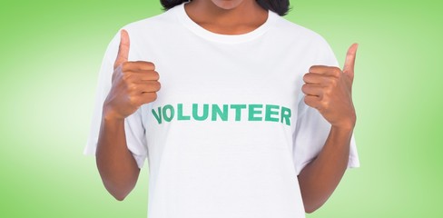 Woman wearing volunteer tshirt and showing thumbs
