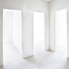 Three doors in white room