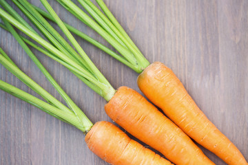 Raw carrots with green tops