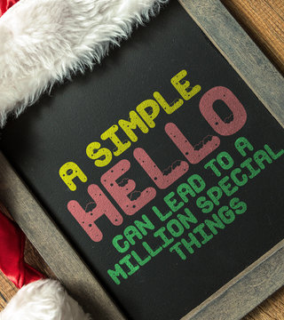 A Simple Hello Can Lead to a Million Special Things written on blackboard with santa hat