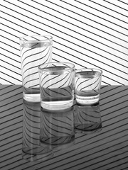 Fototapeta na wymiar Three glasses of water on cloth. Still life. Refraction and reflections.