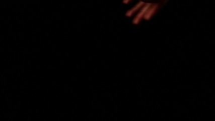 Playing cards being spread on a black surface by magician