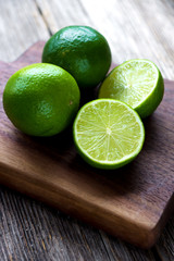 Fresh limes on wooden background