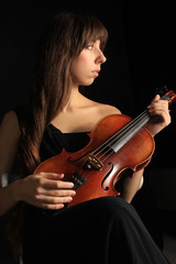 the young nice beautiful girl the musician playing a violin