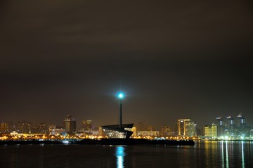 Fototapeta na wymiar Across the bay of the Caspian Sea at night, showing light on rocks and view of the Formula 1 circuit