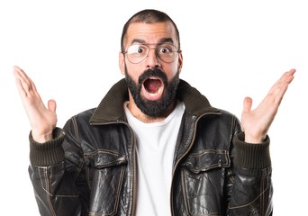 Man wearing a leather jacket doing surprise gesture