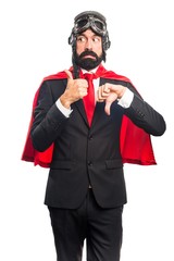Super hero businessman making good-bad sign
