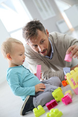 Daddy with baby boy playing with blocks on the floor