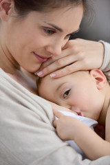 Mom breast feeding baby girl