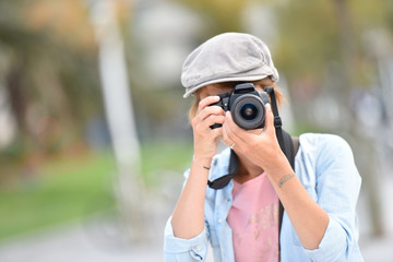 Young woman photographer on a shooting day in town
