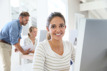 Portrait of smiling student in computing class