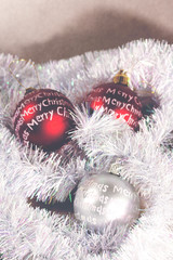 Christmas balls waiting for the christmas tree. Merry Christmas is written on the balls. Image has a vintage effect applied.
