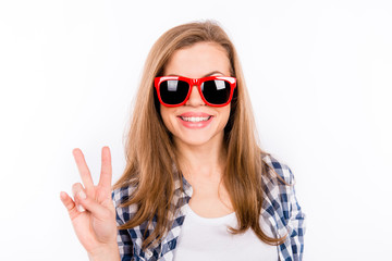 Funny happy girl in glasses showing her fingers
