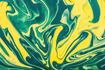 Naklejka premium Yellow and green paint flowing and mixing texture.
