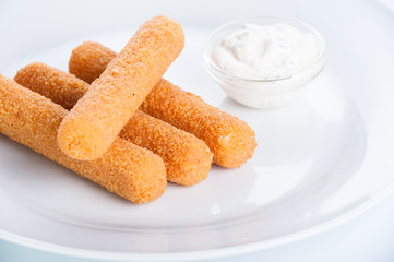 Crispy cheese sticks deep-fried on a white background