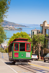 Fototapeta na wymiar San Francisco tram and beautiful Hyde street