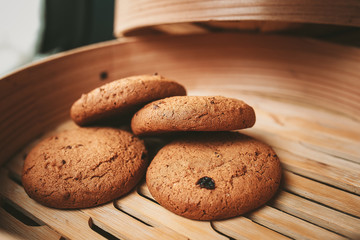 Stacked chocolate chip cookies on brown napkin