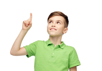 happy boy in green polo t-shirt pointing finger up