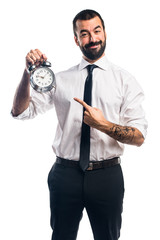 Businessman holding vintage clock