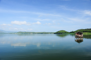 Fototapeta na wymiar Houseboat, lake, moutain and sky in Thailand